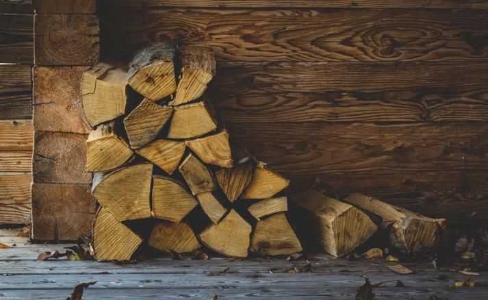 Properly seasoned firewood stacked and ready for wood burning stove use, showing well-prepared fuel supplies for autumn heating season