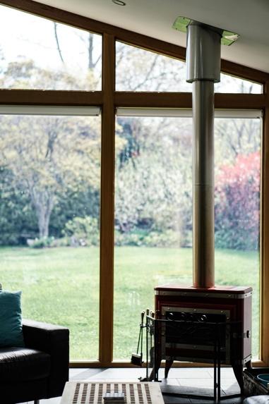Wood burning stove in modern living room setting during autumn, ready for seasonal maintenance and preparation before heating season begins