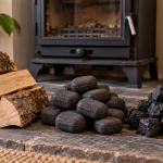 Dry split firewood, manufactured smokeless fuel ovals and anthracite beside a multi-fuel stove