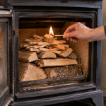 Top-down wood burner fire being lit from the kindling and firelighter at the top of the fuel stack