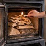 Top-down wood burner fire being lit from the kindling and firelighter at the top of the fuel stack