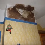 Brown chimney staining above a fireplace on a chimney breast
