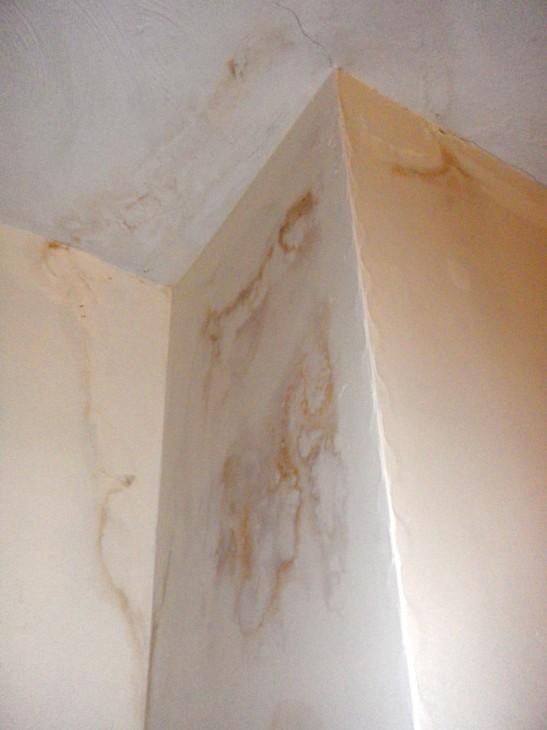 Brown staining on an internal chimney breast indicating a chimney problem