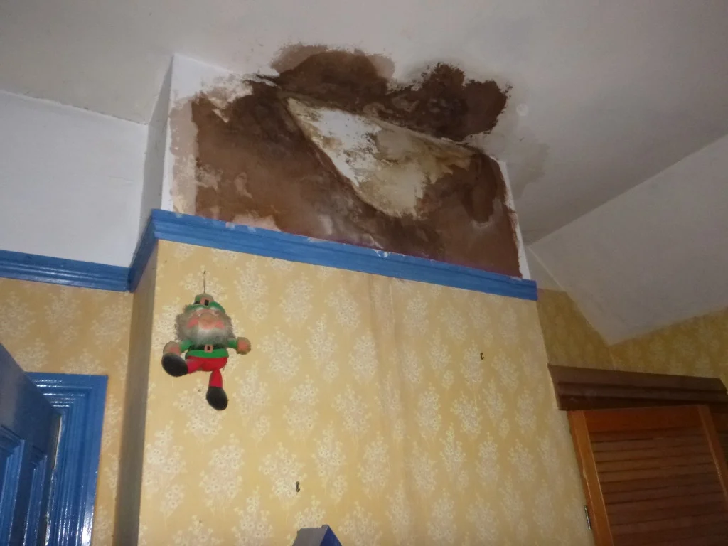 Brown chimney staining above a fireplace on a chimney breast