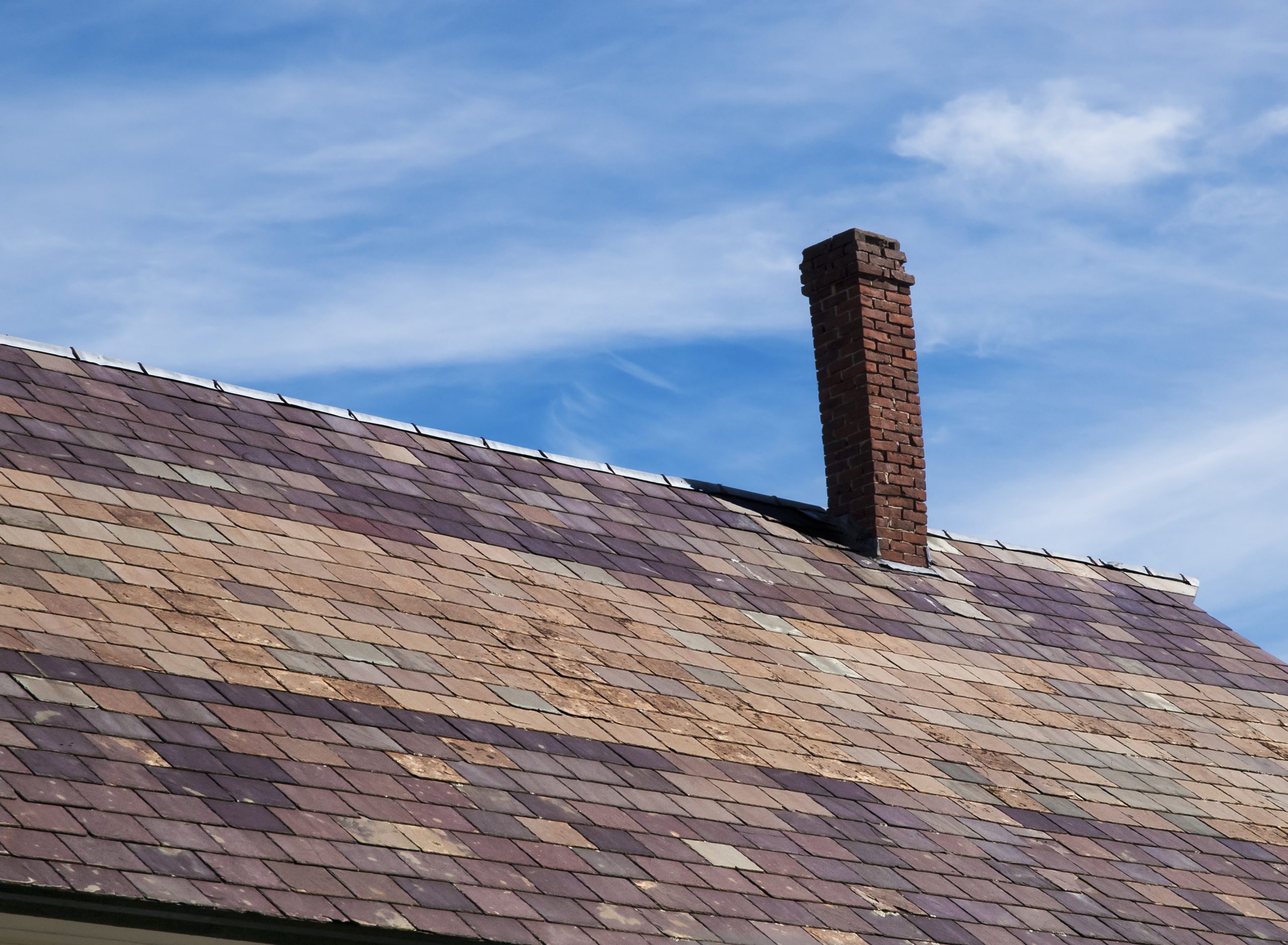 Visibly leaning brick chimney stack requiring urgent attention